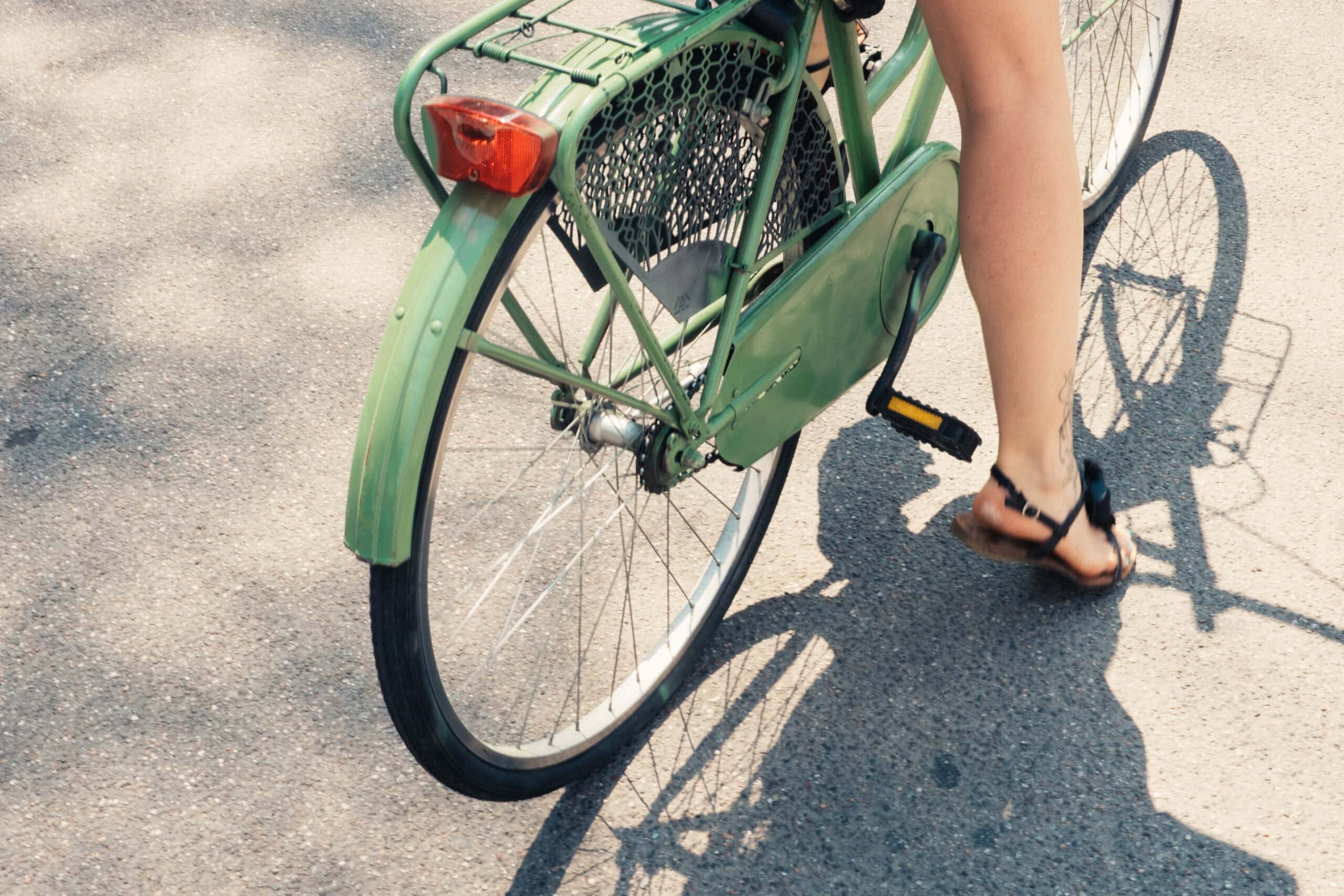 Woman riding a bike near Grace Apartments in Midtown Nashville, TN